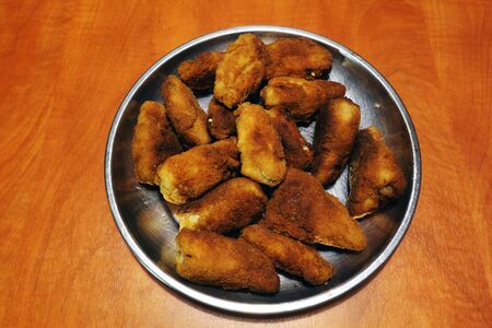 Roast chicken wings on a metal plate