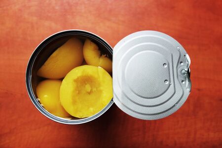 Tin full of peaches in sweet syrupの写真素材