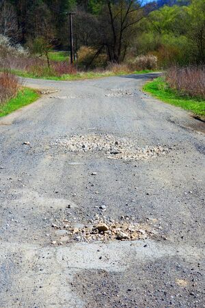 A broken road at a crossroads in natureの写真素材