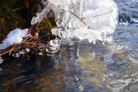 Beautiful icicles on a frozen mountain streamの写真素材