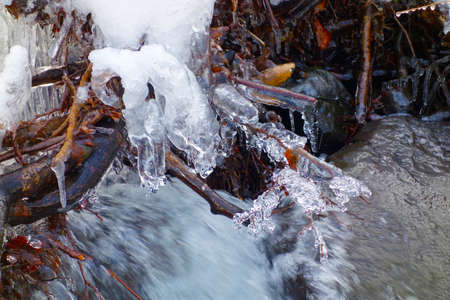 Beautiful icicles on a frozen mountain streamの写真素材