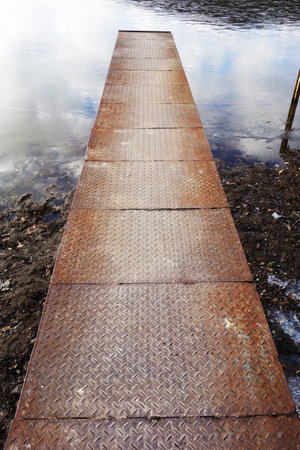 Lake steel pier in a frozen pondの写真素材