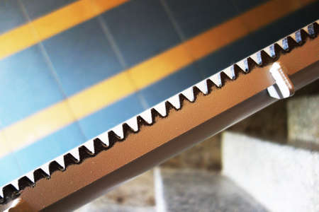 Rail for a stair lift attached to the staircase by the railing of an apartment buildingの写真素材