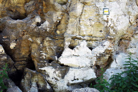 Travertine wall with tourist sign and geothermal holes in the rock, DrevenÃ­k Slovakiaの写真素材