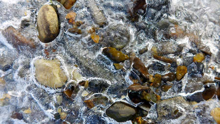Beautiful icicles on a frozen mountain streamの写真素材