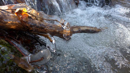 Beautiful icicles on a frozen mountain streamの写真素材