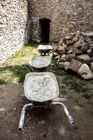 Wheelbarrow full of mortars, renovation work on the old castle Jasenov Slovakiaの写真素材