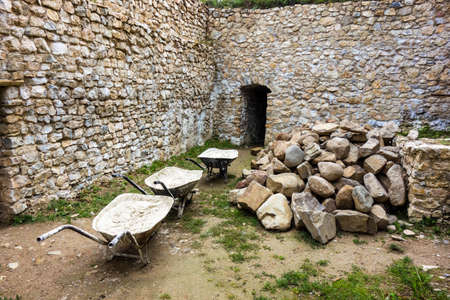 Wheelbarrow full of mortars, renovation work on the old castle Jasenov Slovakiaの写真素材