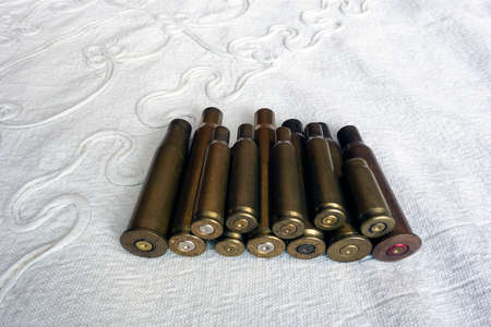 Empty cartridges of various calibers, after shooting, on the work table