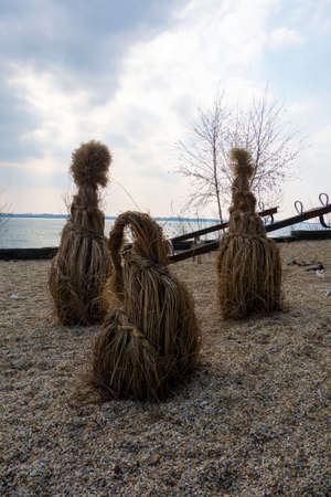 Decoration of dry grass by the wooden walkway by the lake of the recreation center in winterの写真素材
