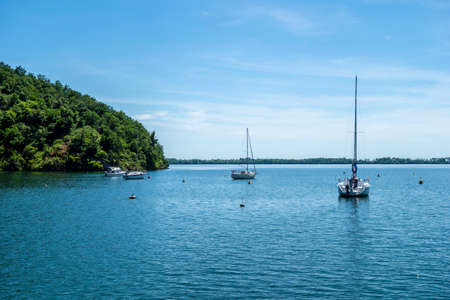 Sailboats moored on the water in the harbor of yachts