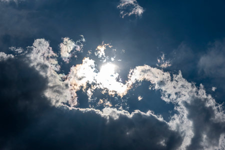 Shining sun over the clouds in summer
