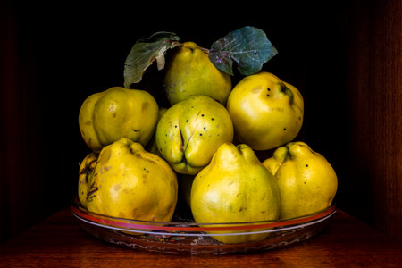 Cydonia oblonga type of apple on a glass dish acting as a decorationの写真素材