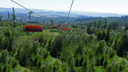 Chair lift for tourists and skiers in the High Tatras, rocky lake