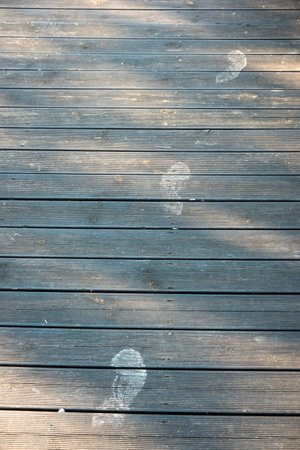 Human footprints on the wooden floor in the exteriorの写真素材
