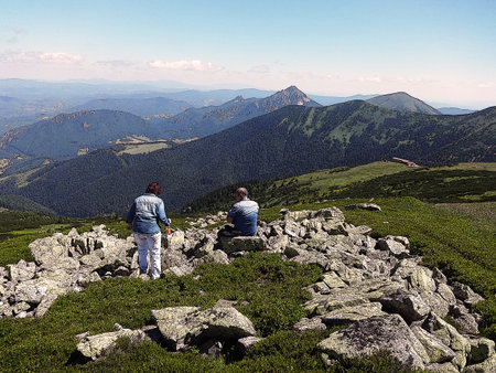 A tourist has conquered the top of a mountain in the Tatras