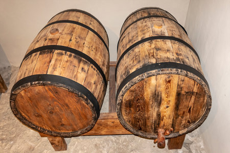A wooden barrel with wine in the cellar