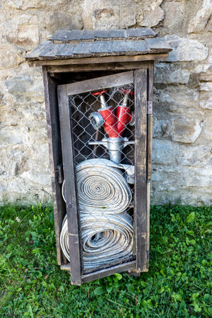 Wooden cabinet with fire extinguisher equipment in the castle