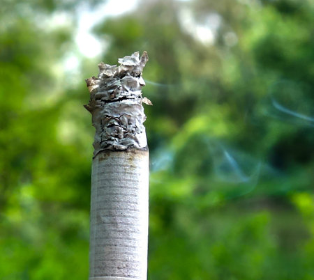 Burning cigarette with smoke