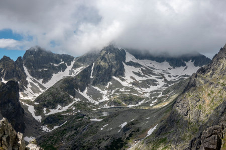 The cold valley of the five SpiÅ¡ Lakes with a mountain hut, view from Lomnicke saddle High Tatras Slovakiaの写真素材
