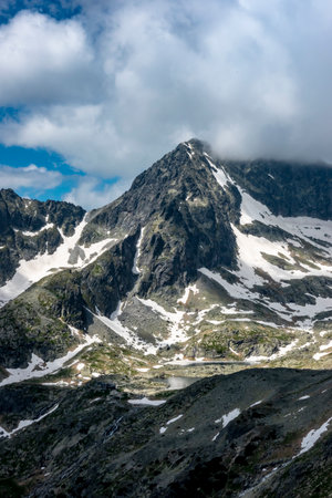 The cold valley with a mountain hut, view from Lomnicke saddle High Tatras Slovakiaの写真素材
