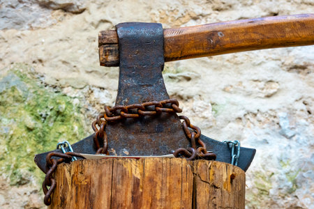 A historical ax stuck in a tree stump from the Middle Agesの写真素材