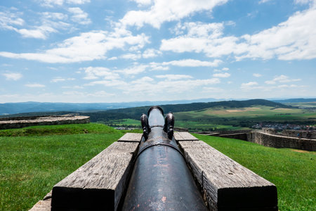 A historical cannon at the Spis castle in Slovakia symbolically aimed behind the walls to defend it