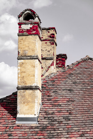 An antique house with an original preserved roof with a chimney, a historical monumentの写真素材