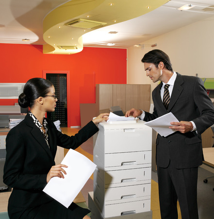 young businesswoman making copies on the photocopy machine at the office