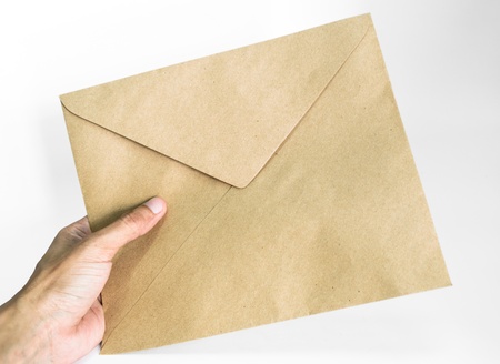 Hand holding an envelope isolated on white background Studio shot 