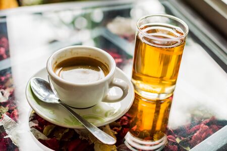 Coffee and tea on glass table.の写真素材