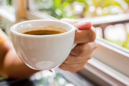 Woman hands with cup of coffee 