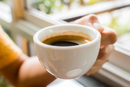 Woman hands with cup of coffee の写真素材