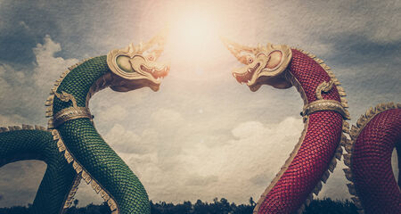Vintage photo of Thai dragon or king of Na-ga statue, With sunshine on sky background.の写真素材