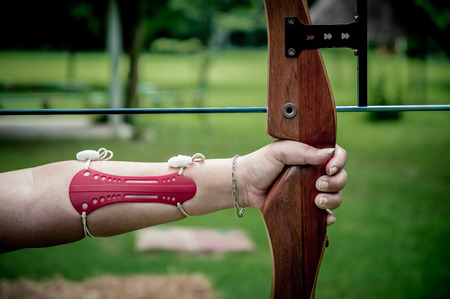 Young women  holds her bow aimingの写真素材