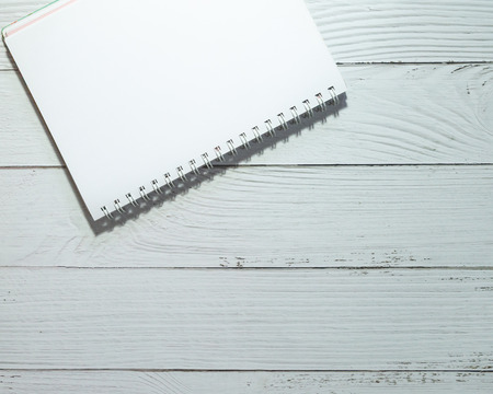 Closeup blank notebook on wooden background, Top view. For art design or web design and your text design.の写真素材