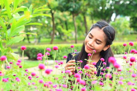 woman with flowers in gardenの写真素材