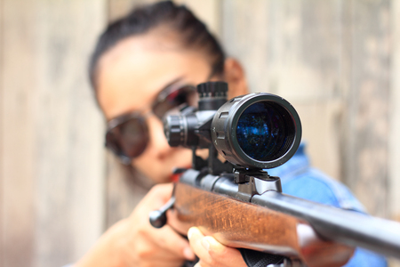 The woman at the shooting range shot from a rifle.の写真素材