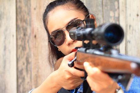 The woman at the shooting range shot from a rifle.の写真素材