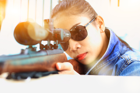The woman at the shooting range shot from a rifle.
