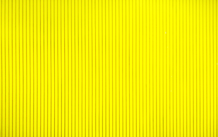 abstract background concept,close up beautiful texture yellow wall and simple design of straight line for interior decorative,wooden material wallpaper of modern style,copy space and pattern orderlyの写真素材