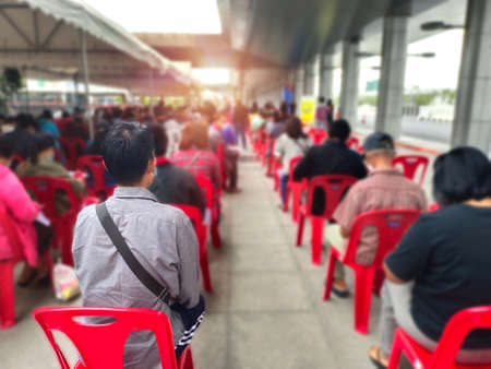 many people waiting for   vaccination,young man and many people waiting medical and health services to the hospital,  patients waiting treatment at the hospitalの写真素材