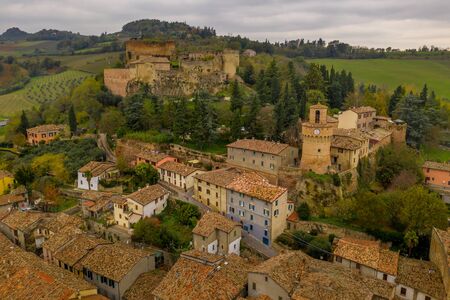 Aerial view of thermal spa town, Gothic medieval castle fortezza and colorful houses in Castrocaro Terme, Cesena Forli province, Emilia Romagna, Italyの写真素材