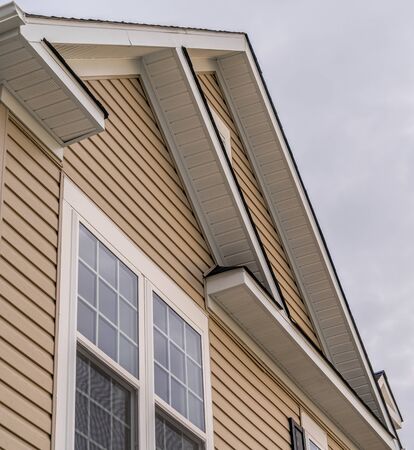 White attic gable vent louver ,white square window,  triangle with red brick or gray beige...