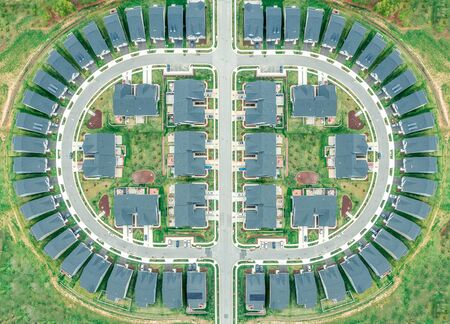 Aerial view of the perfect symmetric American residential neighborhood, single family homes built close to each other around a semi circle separated by a cross street in Marylandの写真素材