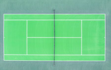 Aerial top down view of a tennis court  green pavement, baseline, singles' sideline, doubles' sideline, net, net posts, center mark, service line, doubles alley, at new American residential communityの写真素材