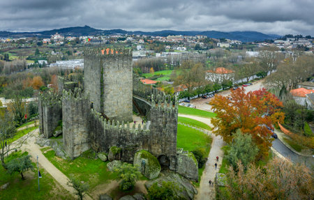 Aerial view of well-preserved medieval buildings hilltop, 10th-century GuimarÃ£es Castle with its sweeping city views. Restored Dukes of BraganÃ§a Palace, Romanesque SÃ£o Miguel do Castelo Churchのeditorial素材