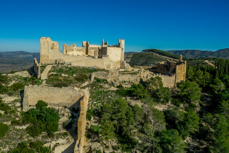 Aerial panorama view of Alcala de Xivert (AlcalÃ¡ de Chivert) medieval Templar knight castle ruins in Valencia province Spainの写真素材