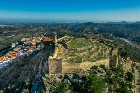 Aerial view of Cervera del Maestre castle with ruined excavated inner building remains surrounded by a partially restored outer wall of Arab originの写真素材