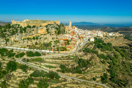 Aerial view of Cervera del Maestre castle with ruined excavated inner building remains surrounded by a partially restored outer wall of Arab originの写真素材